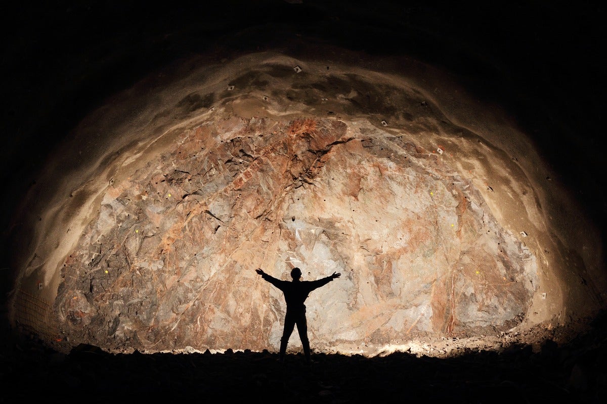 Mine, tunnel front, silhouette of a successful miner/worker.